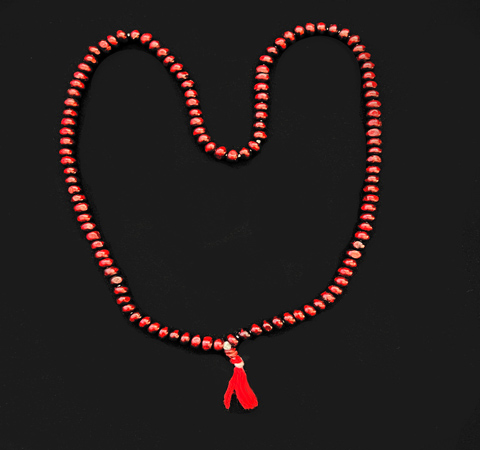 small red wood beads on red thread